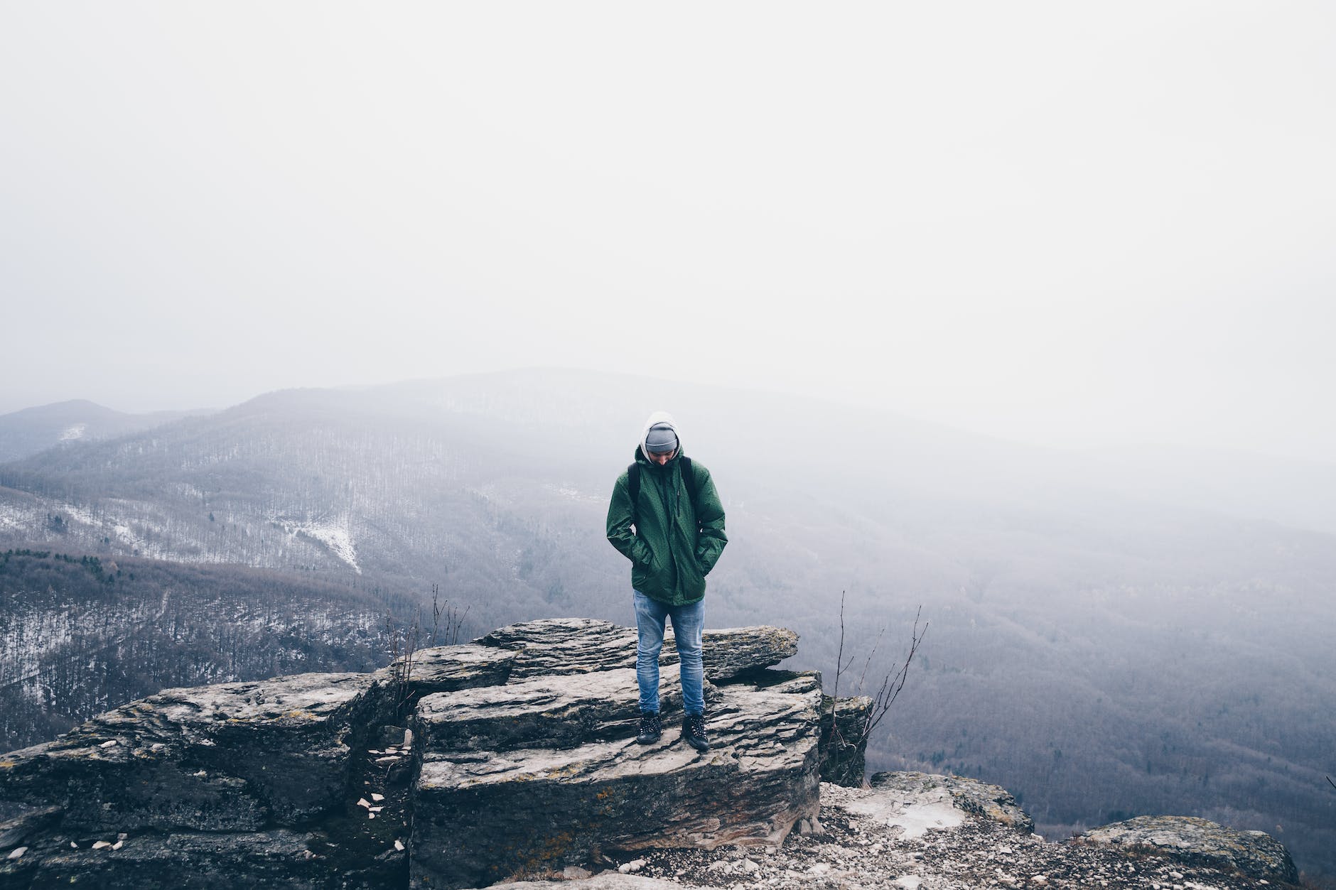 man wearing green full zip snow jacket