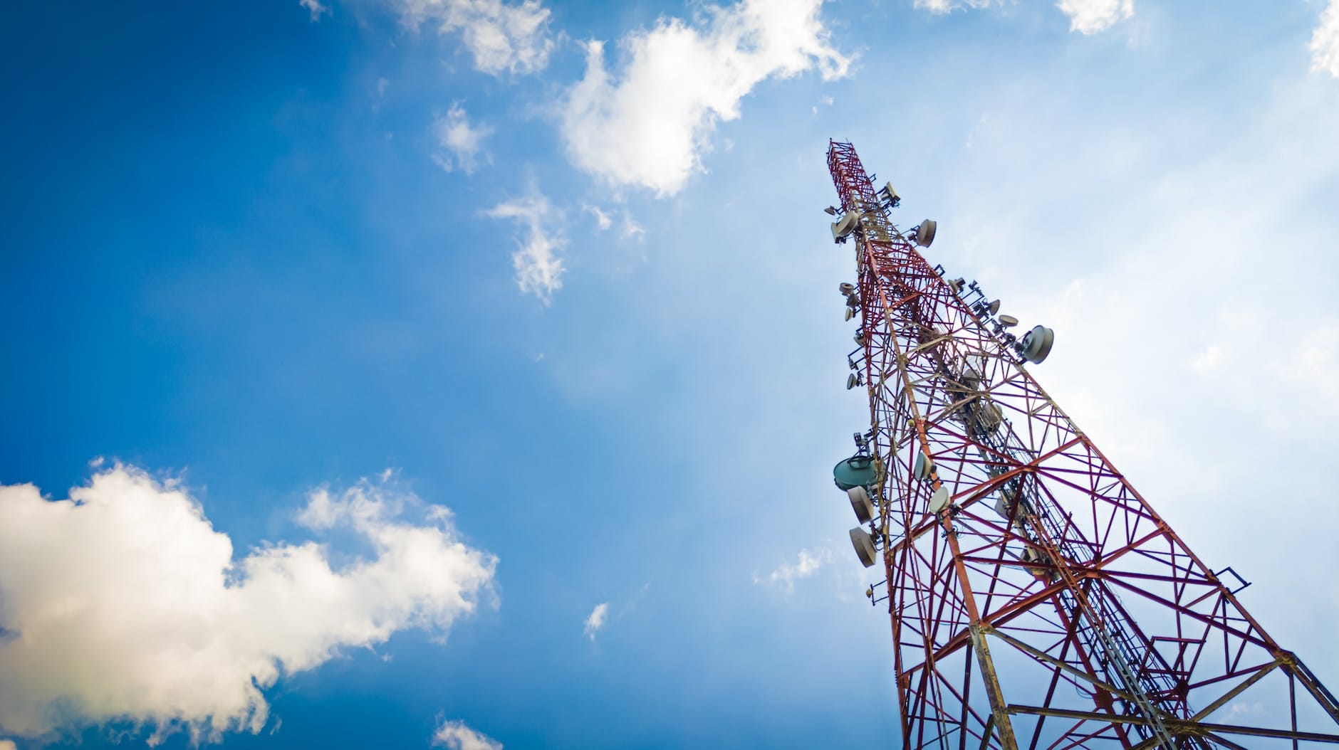 telecommunication tower under cloudy and blue sky wireless communication and information technology concept